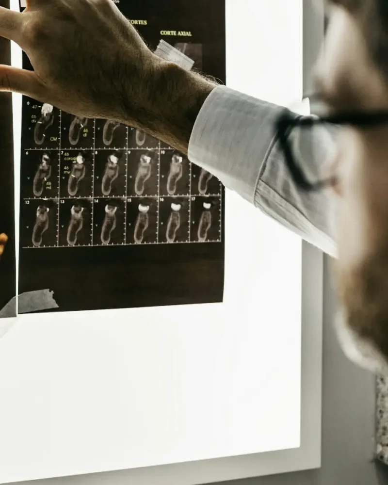 Doctor reviewing dental x-rays, requiring secure IT services and HIPAA compliance for the healthcare industry.